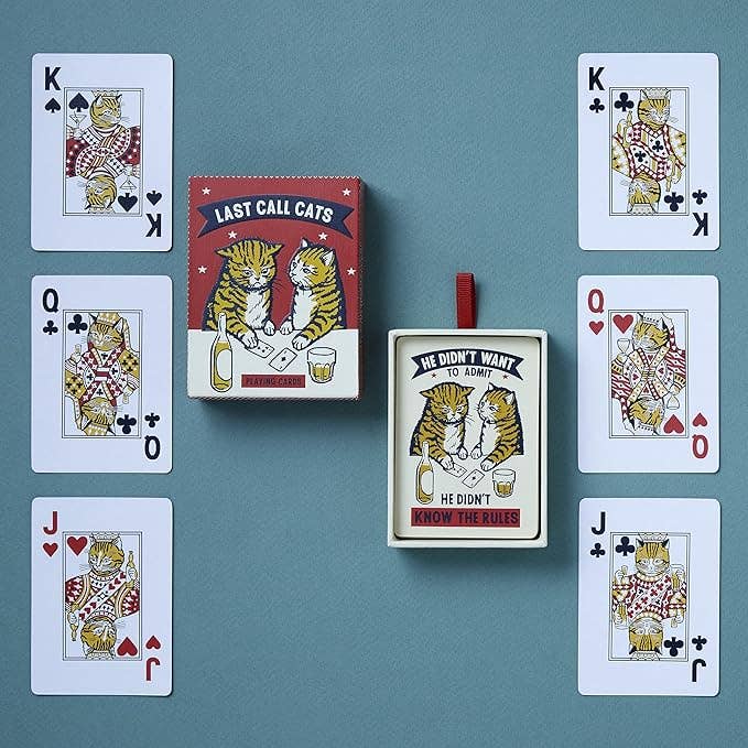 Court cards fanned around the box on a blue background, kings, queens and jacks illustrated as cats