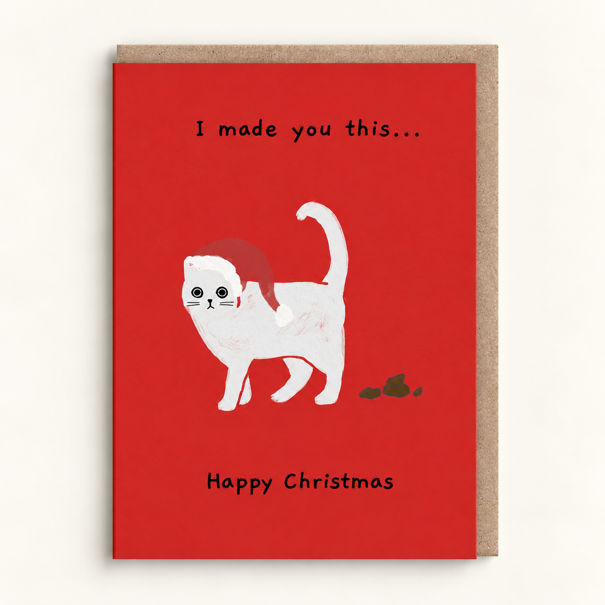 I Made You This Christmas Card by Ken the Cat: a white cat in a Santa hat walking away from a small gift on a bright red card reading I made you this... Happy Christmas, with a brown kraft envelope