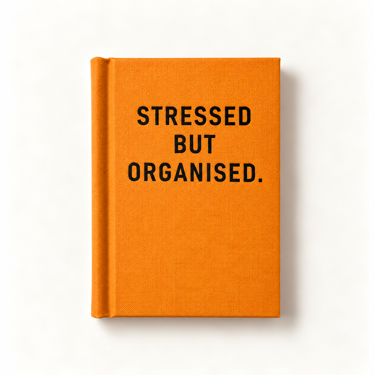 Stressed but Organised A7 fabric hardback notebook by Ohh Deer, orange linen cover with bold black capitals, studio shot