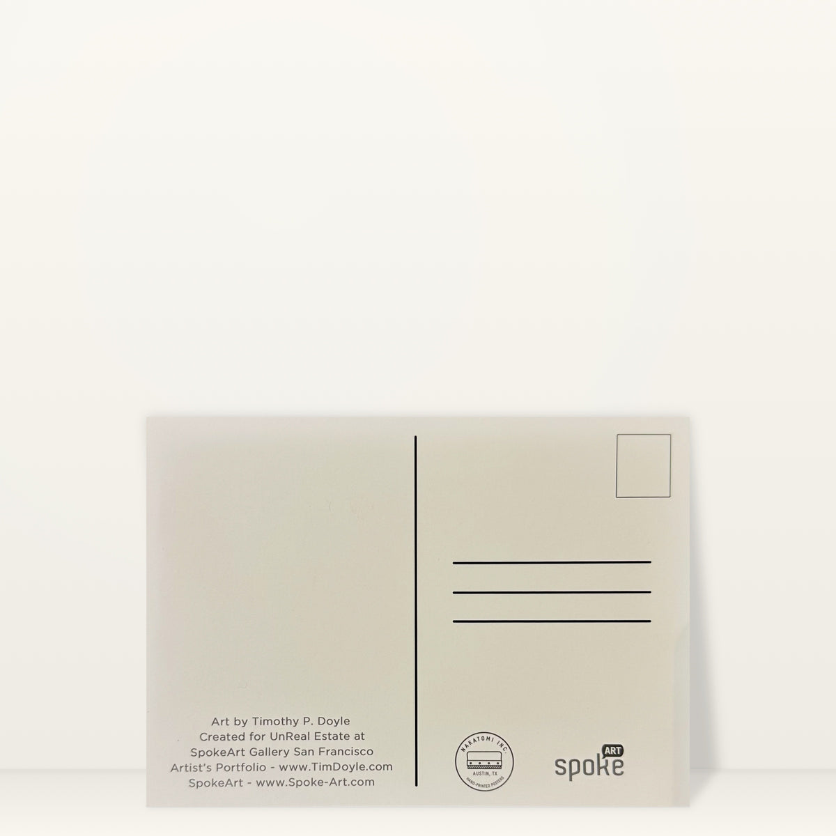 Back of a Springfield mini print postcard by Tim Doyle, with a stamp box, address lines and Spoke Art and Nakatomi credits