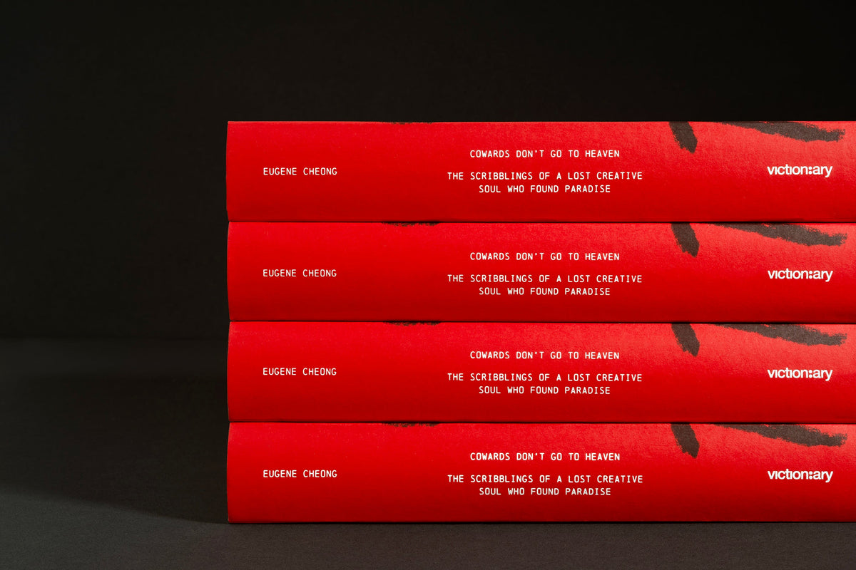 Stacked spines of Cowards Don't Go to Heaven showing the Victionary logo
