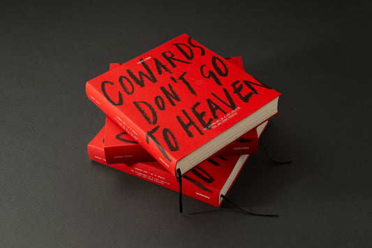Two copies of Cowards Don't Go to Heaven by Eugene Cheong with its red hand-lettered cover