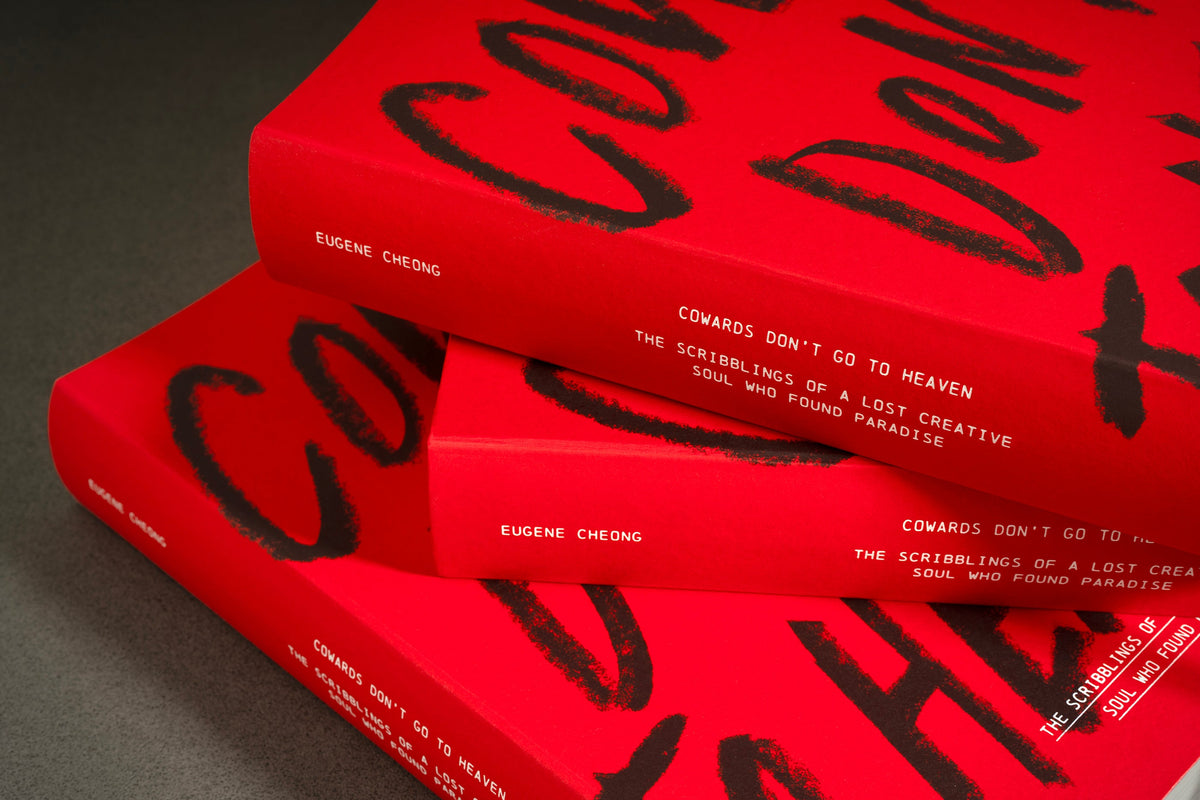 Close-up of the hand-lettered red cover of Cowards Don't Go to Heaven
