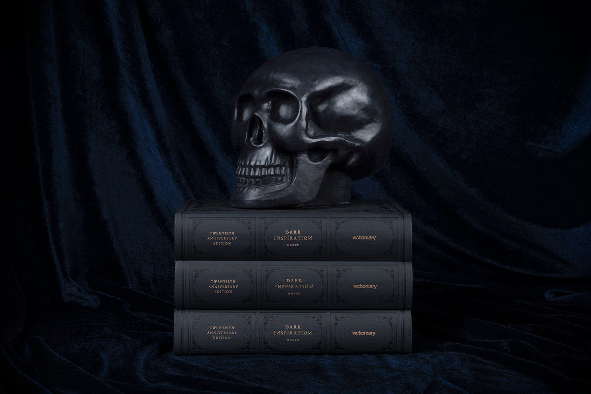 Stacked copies of Dark Inspiration beneath a black skull