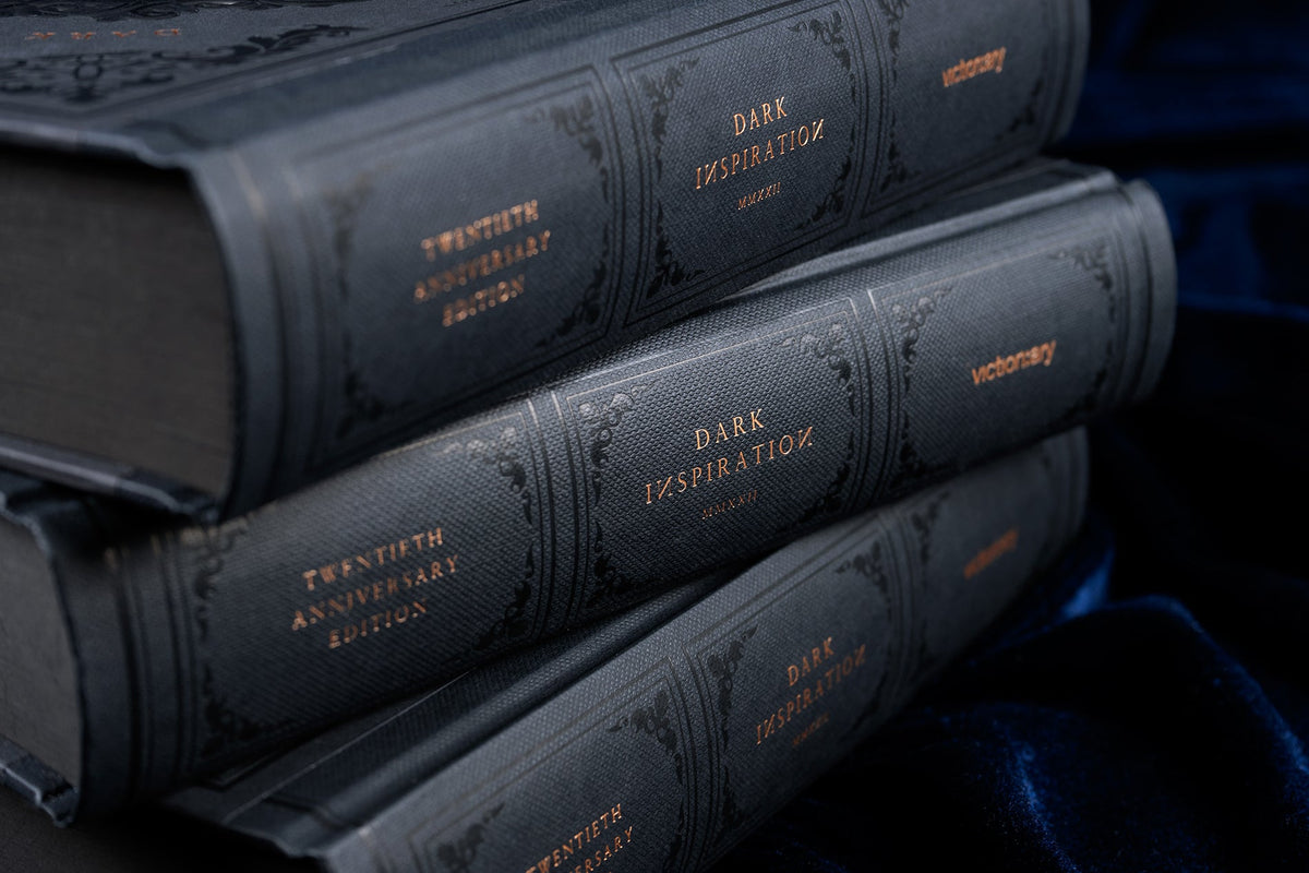 Close-up of the spines of stacked Dark Inspiration hardcovers