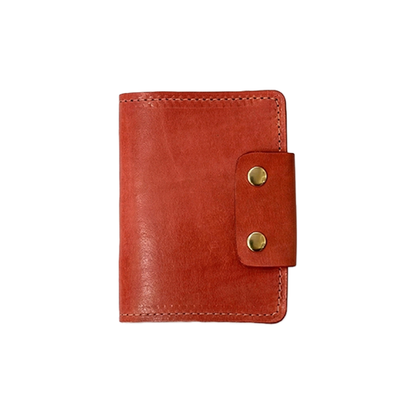 Red leather wallet with gold buttons on a white background
