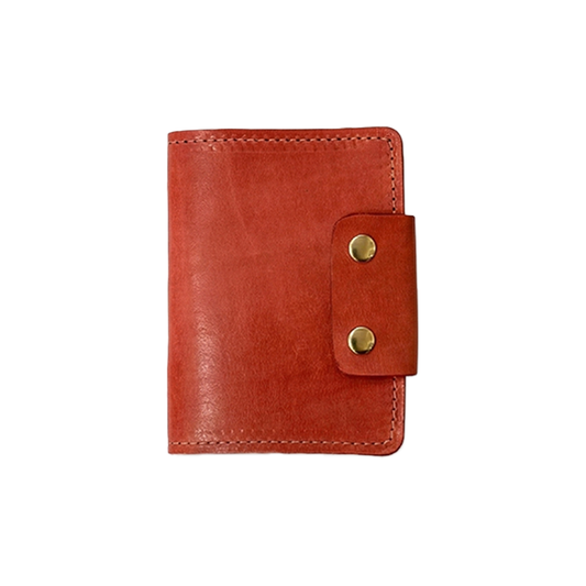 Red leather wallet with gold buttons on a white background