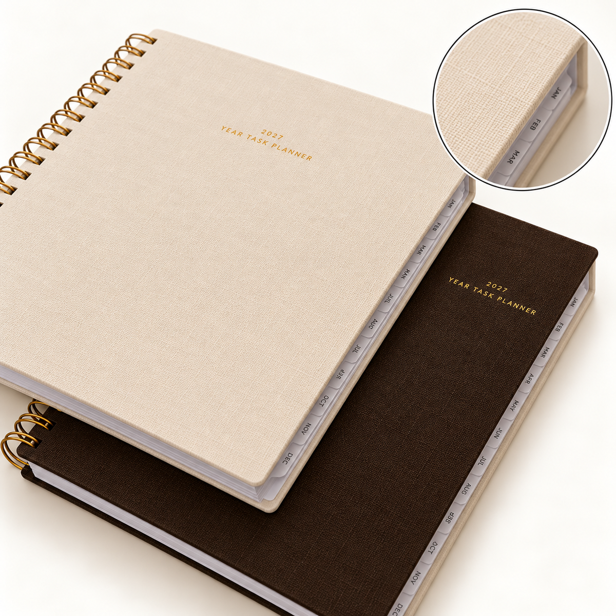 Appointed 2027 Year Task Planner in Natural Linen and Espresso bookcloth with gold foil titles, brass wire-o binding and monthly tabs, with a close-up of the linen texture