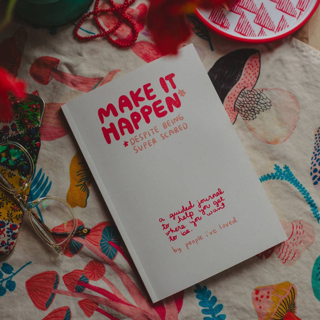 Make It Happen journal on a colorful tablecloth