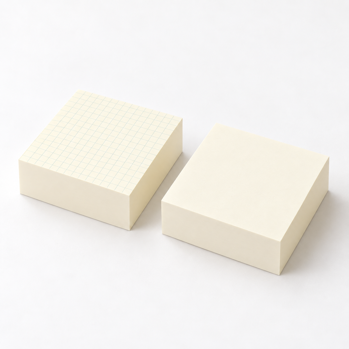 Thick cream note pads shown together, one with a pale grid and one blank.