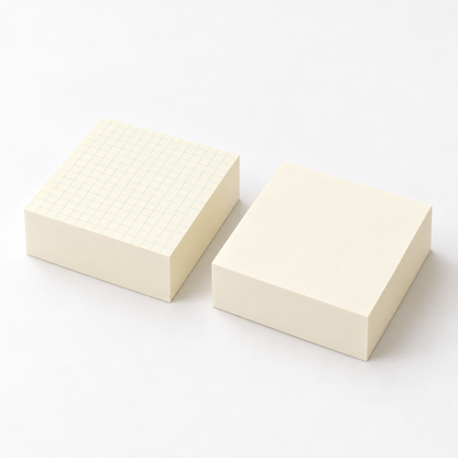Thick cream note pads shown together, one with a pale grid and one blank.