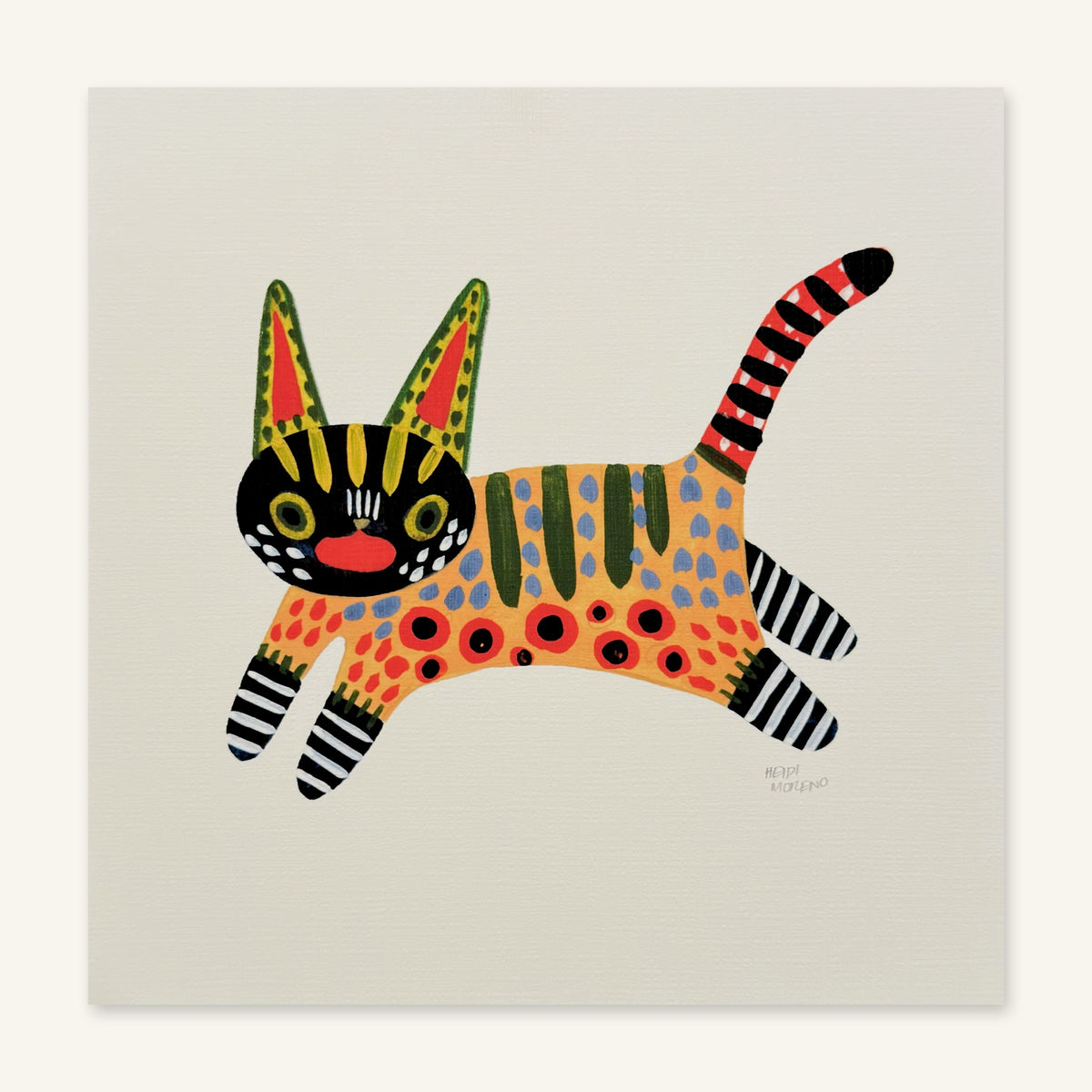Leaping cat painted in alebrije style with a black face, spotted orange body, striped legs and a red striped tail, art print by Heidi Moreno shown flat