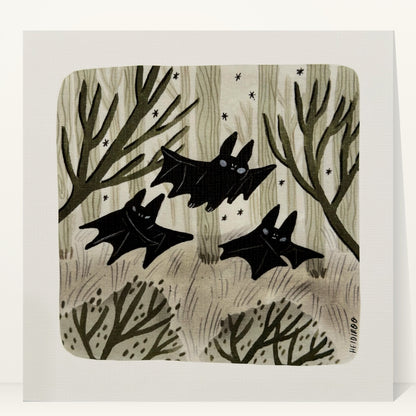Three black bats flying through a sage-green forest of pale trees and bare branches with small stars, art print by Heidi Moreno
