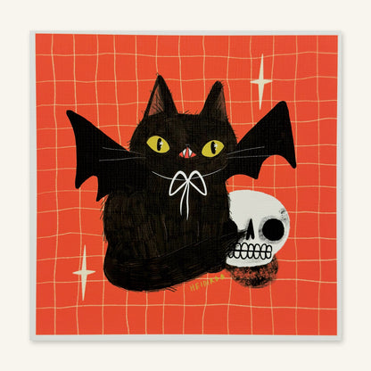 Black cat with bat wings and a white bow beside a grinning skull on a red-orange grid background, art print by Heidi Moreno shown flat