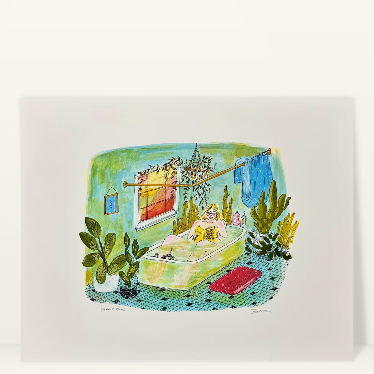 Swamp Thing art print by Jill Kittock, 14 x 11 size, against a light studio wall: a woman reading in a green tub surrounded by plants