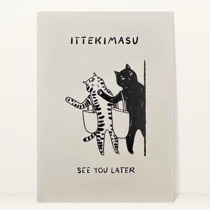 Ittekimasu mini art print by Linnan Ye: tabby cat and black cat with tote bags heading out a door, with the words “Ittekimasu” and “See you later”