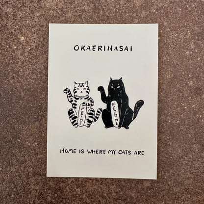 Okaerinasai mini art print by Linnan Ye photographed on a speckled stone surface