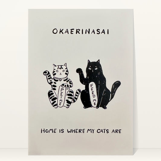 Okaerinasai mini art print by Linnan Ye: tabby cat and black cat holding “Feed me” signs, with the words “Okaerinasai” and “Home is where my cats are”