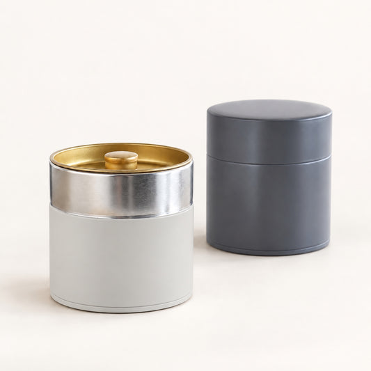 SALIU tinplate tea caddies in Gray-White and Light Black, one with the outer lid off to show the inner lid