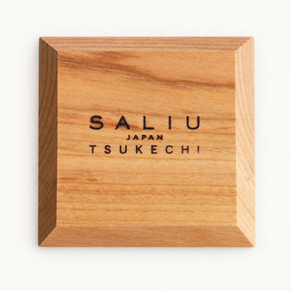 Underside of the square SALIU coaster with the SALIU Japan Tsukechi brand mark and beveled edges