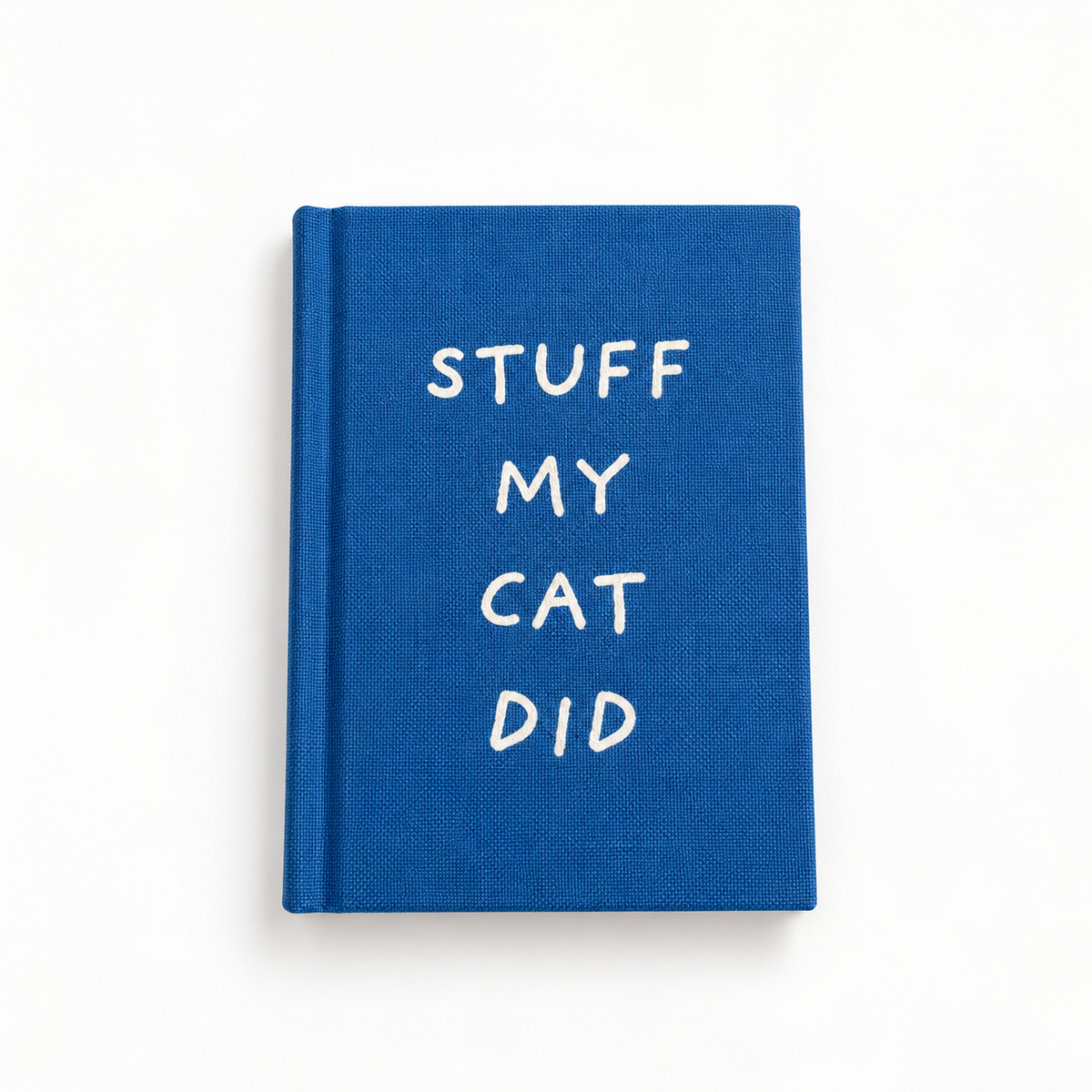 Stuff My Cat Did A7 fabric hardback notebook by Ohh Deer, royal blue linen cover with hand-lettered white type, studio shot