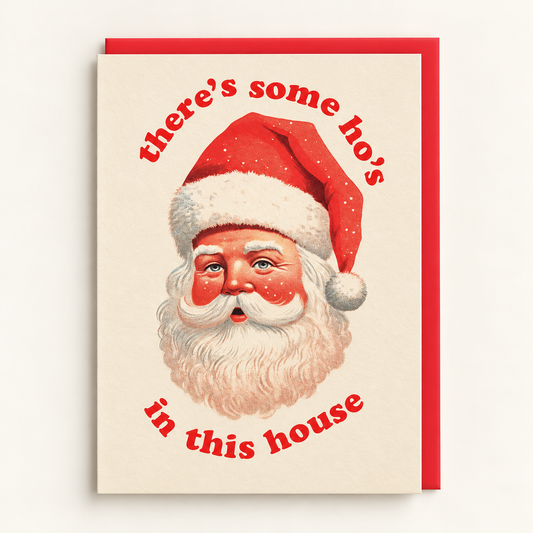 There's Some Ho's In This House Christmas Card by Ohh Deer: vintage-style Santa portrait framed by red lettering on a warm beige card, with a red envelope