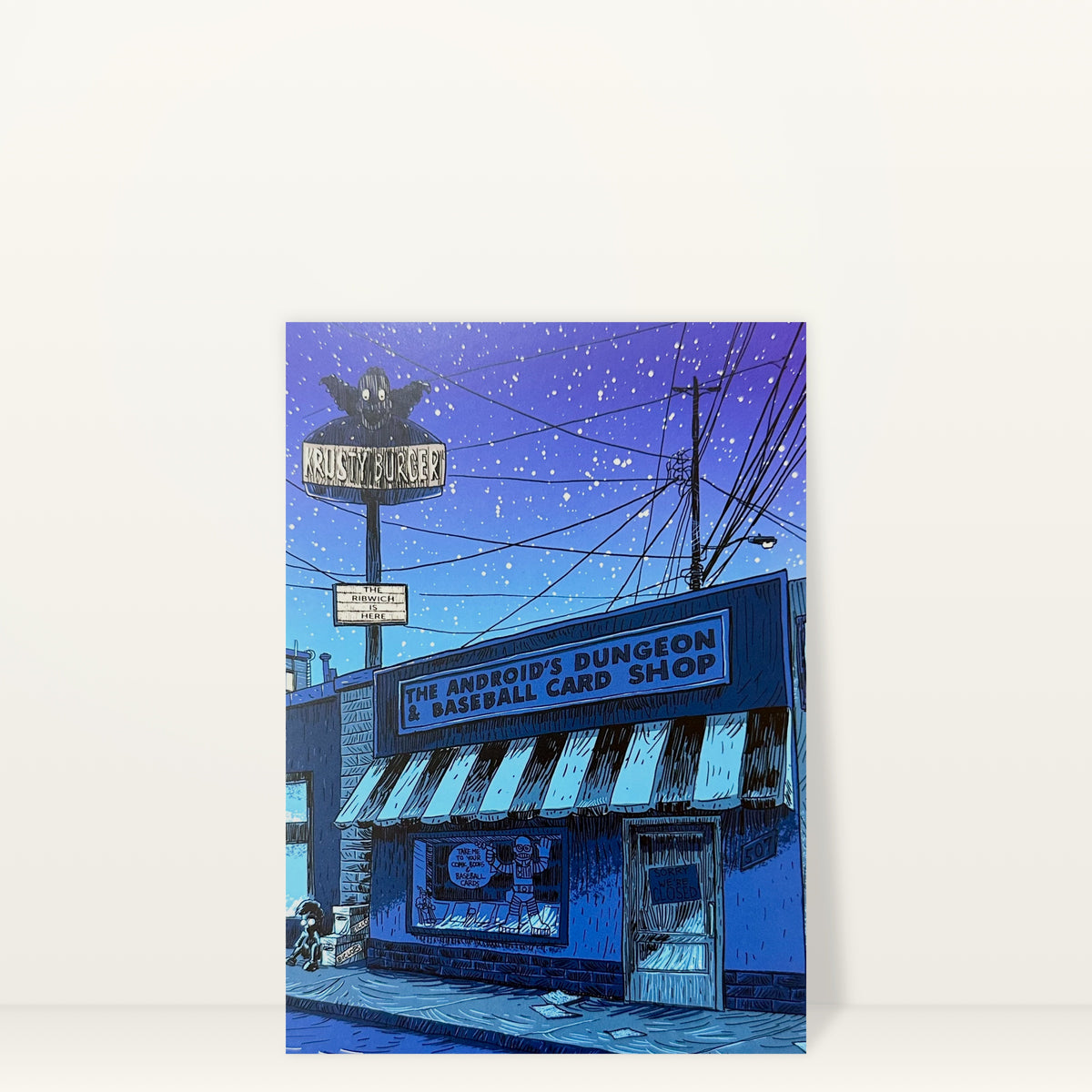 Android's Dungeon (Night) mini print postcard by Tim Doyle: the Android's Dungeon & Baseball Card Shop at night under a purple starry sky