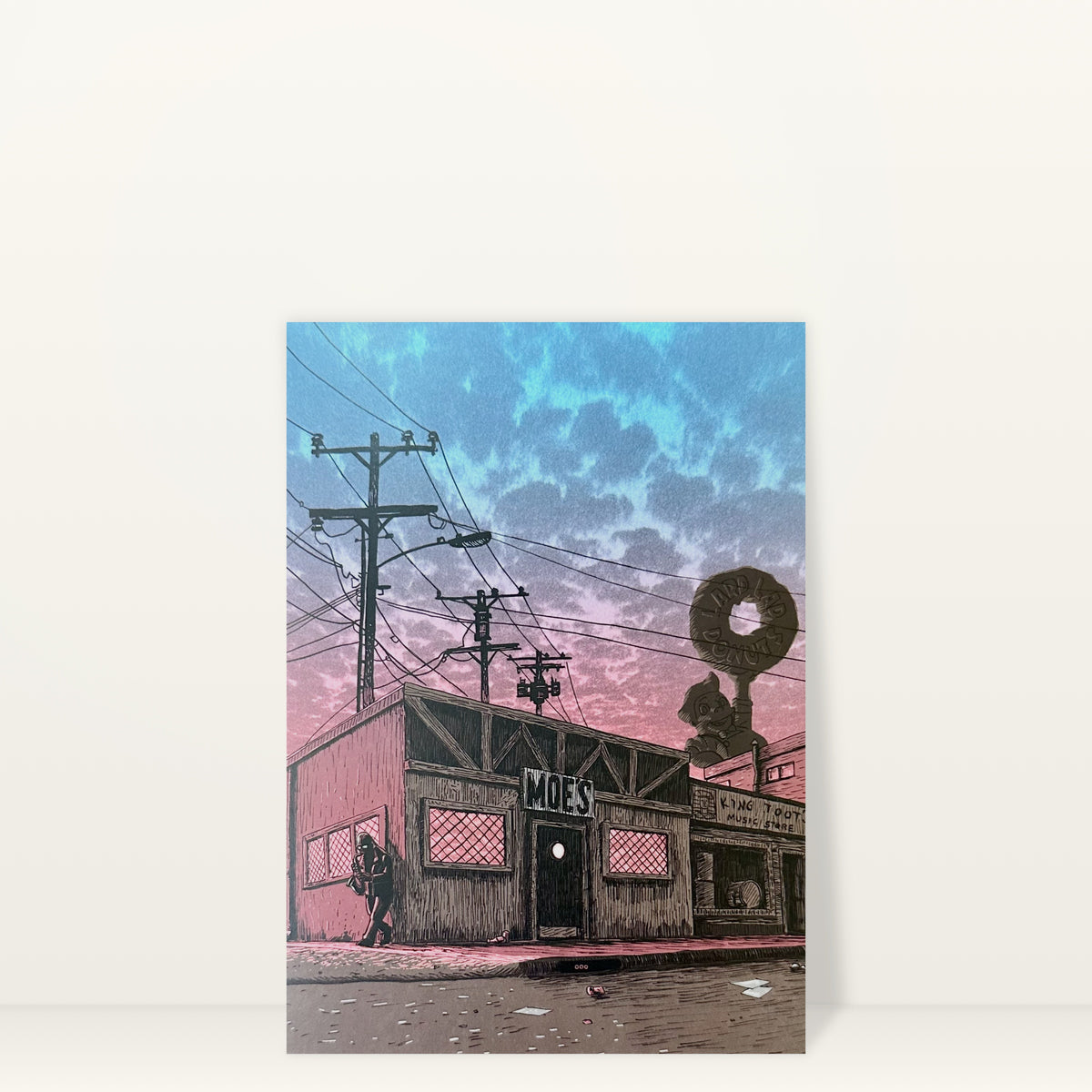 Moe's Tavern (Day) mini print postcard by Tim Doyle: Moe's Tavern under a pink and blue sky