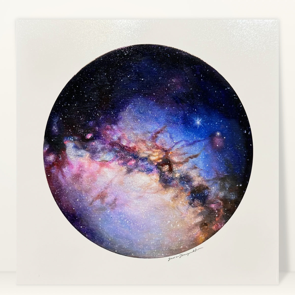 Rosette Nebula art print by Trisha Thompson Adams: a round window of indigo, rose and amber deep space, studio photo on a light background